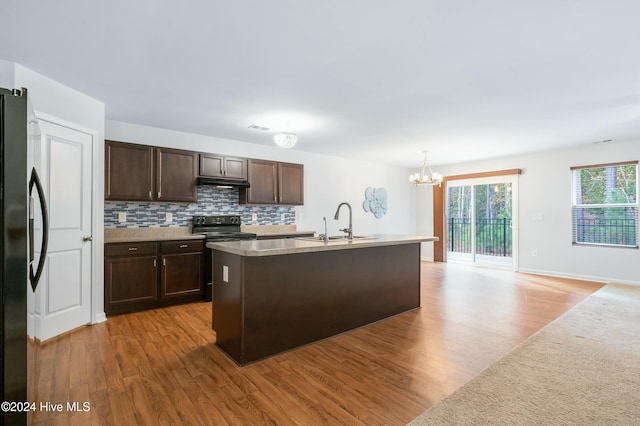 kitchen with electric range, refrigerator, and light hardwood / wood-style floors