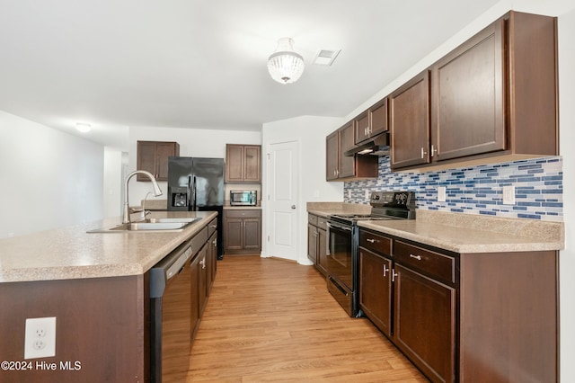 kitchen with black appliances, sink, decorative backsplash, light wood-type flooring, and dark brown cabinetry