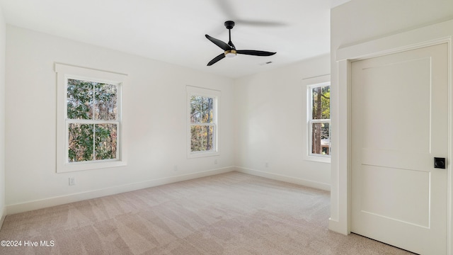 unfurnished bedroom featuring light colored carpet and ceiling fan