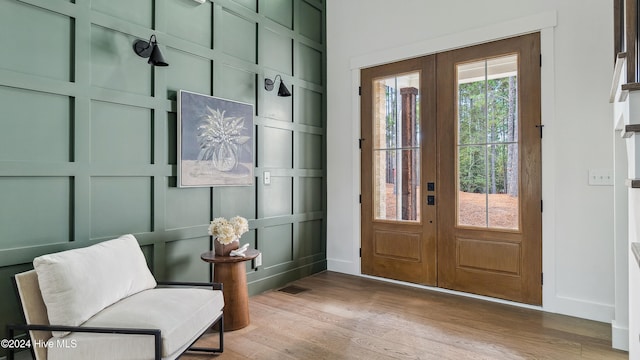 interior space with french doors, light hardwood / wood-style floors, and plenty of natural light