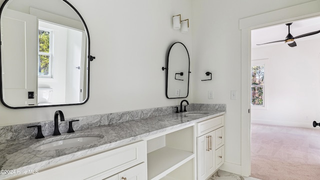 bathroom with ceiling fan and vanity