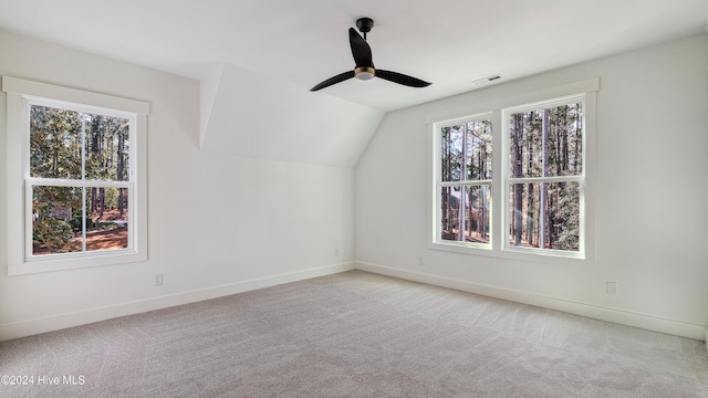 bonus room featuring light colored carpet, vaulted ceiling, plenty of natural light, and ceiling fan