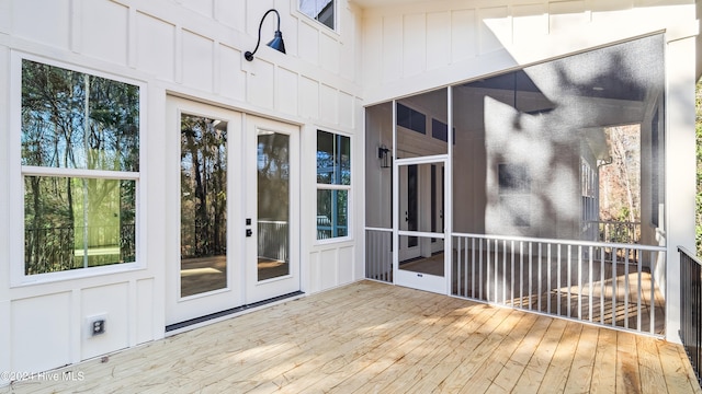 wooden deck with a sunroom