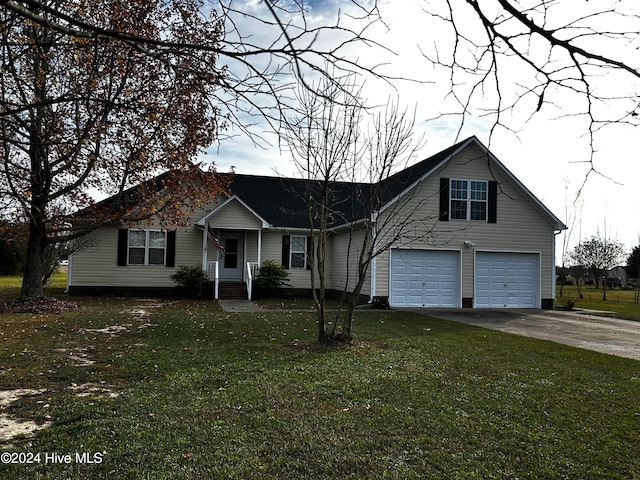 view of front of house with a garage and a front lawn