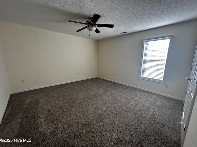 carpeted spare room with ceiling fan and a textured ceiling