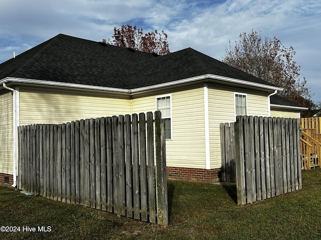 view of side of property with a yard