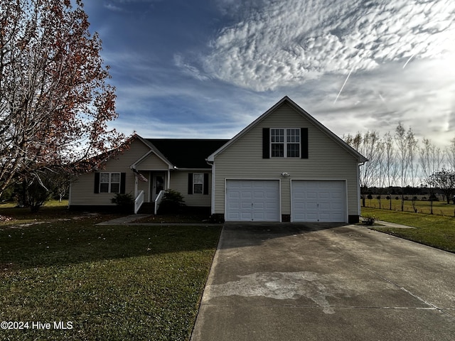 view of front of home with a garage and a front lawn