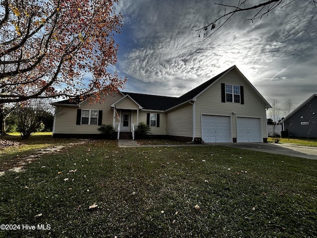 view of front of house featuring a front yard and a garage