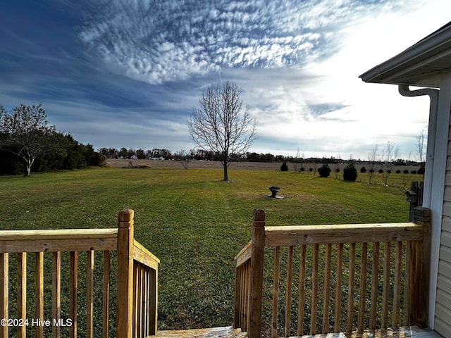 view of yard with a rural view and a deck