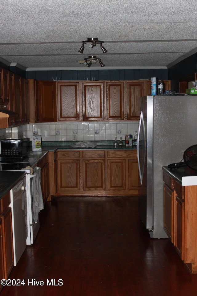 kitchen with decorative backsplash, dark hardwood / wood-style floors, and stainless steel appliances