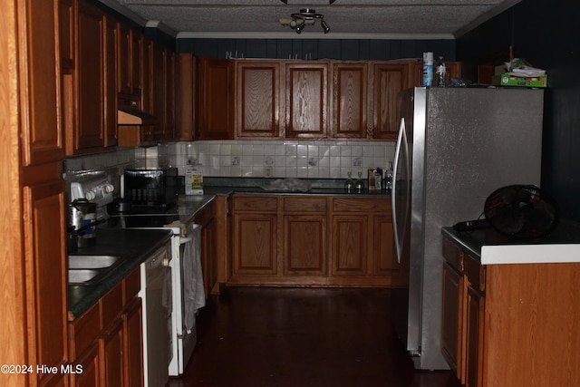 kitchen featuring stainless steel appliances, dark hardwood / wood-style floors, backsplash, a textured ceiling, and ornamental molding