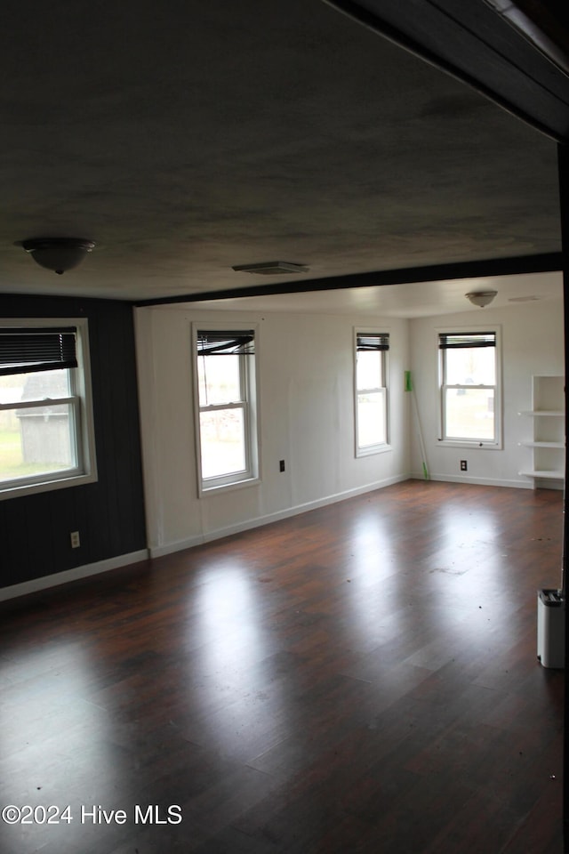 spare room featuring dark wood-type flooring