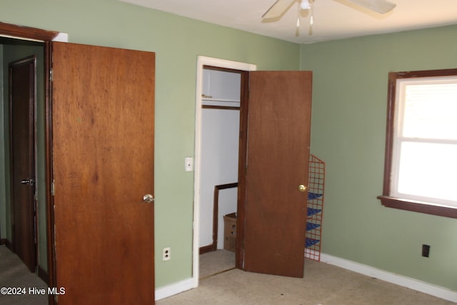 unfurnished bedroom featuring a closet, ceiling fan, and light colored carpet