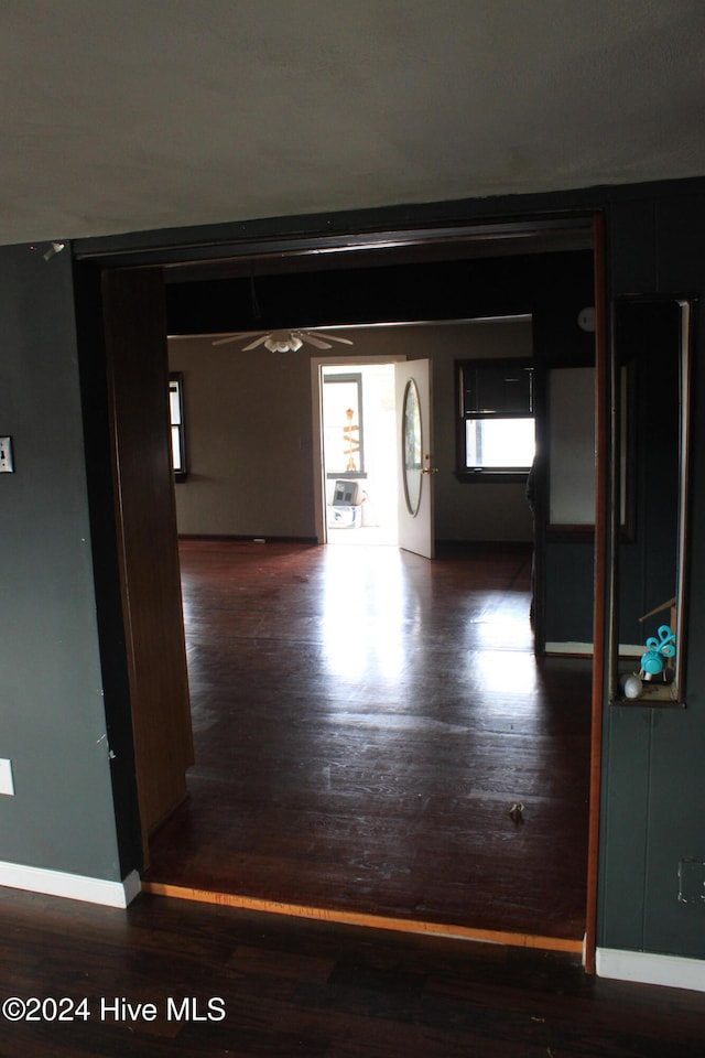 hallway with dark hardwood / wood-style flooring