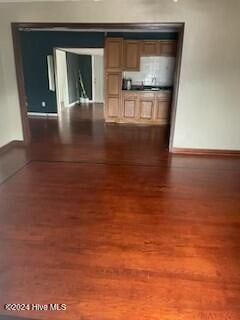 unfurnished living room with dark hardwood / wood-style floors