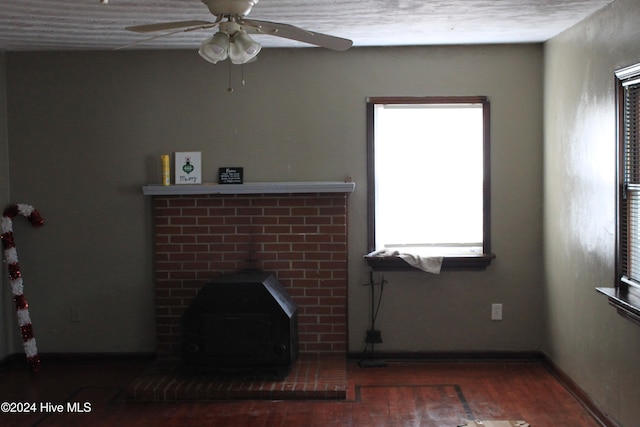 unfurnished living room with ceiling fan and dark hardwood / wood-style floors