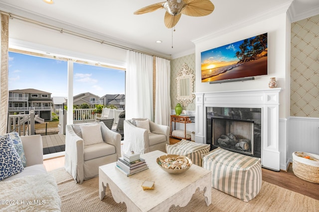 living room featuring ceiling fan, light hardwood / wood-style floors, and ornamental molding