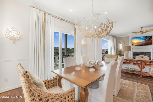 dining space with ceiling fan, wood-type flooring, and ornamental molding