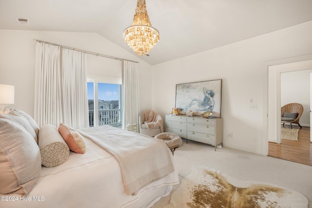 carpeted bedroom with access to exterior, lofted ceiling, and a notable chandelier