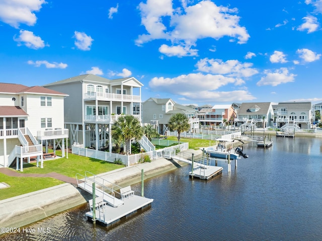 dock area with a lawn and a water view