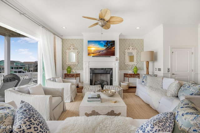 living room featuring ceiling fan, light wood-type flooring, and ornamental molding