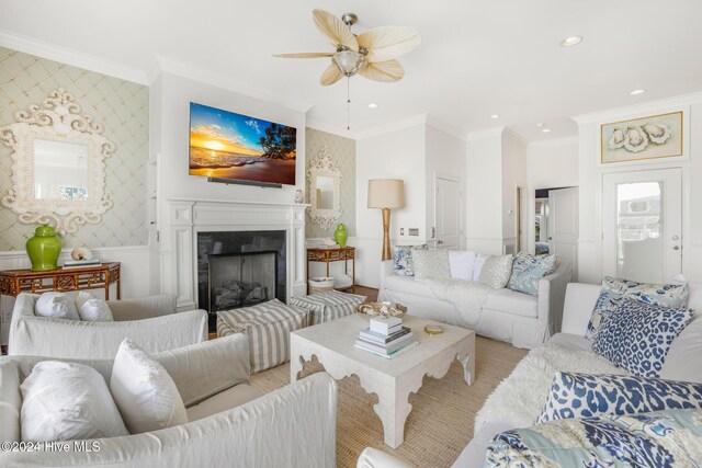 living room with wood-type flooring, ceiling fan, and crown molding