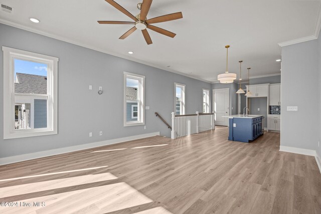 kitchen featuring white cabinetry, sink, appliances with stainless steel finishes, and an island with sink