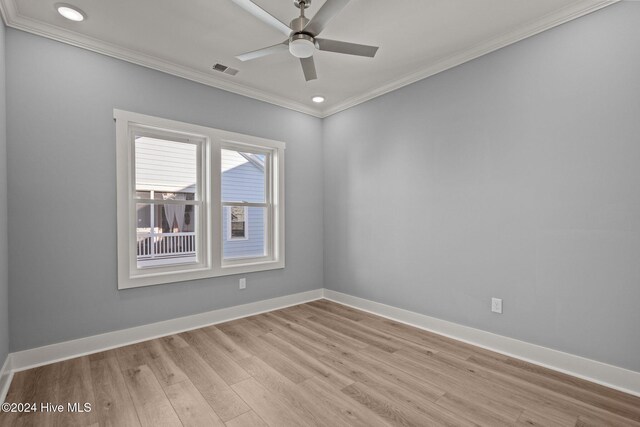 spare room with a wealth of natural light, ceiling fan, light hardwood / wood-style floors, and ornamental molding