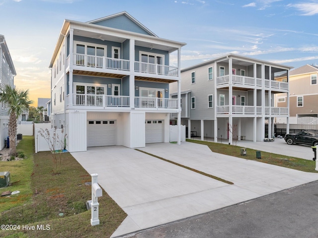 coastal home featuring concrete driveway, board and batten siding, and an attached garage