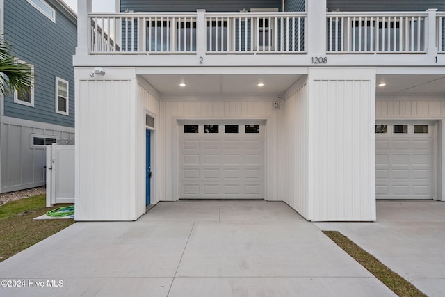 garage featuring concrete driveway