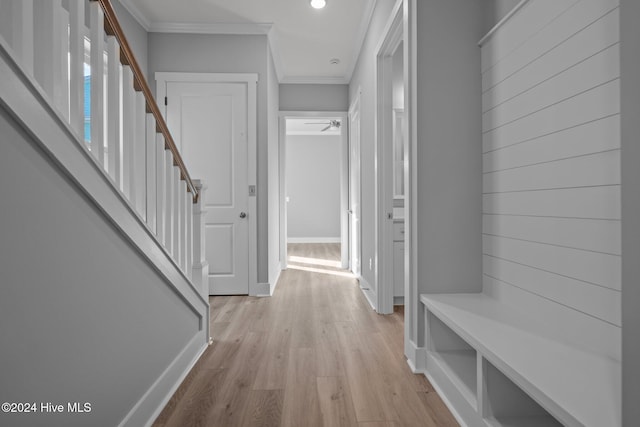 mudroom with light hardwood / wood-style flooring and ornamental molding