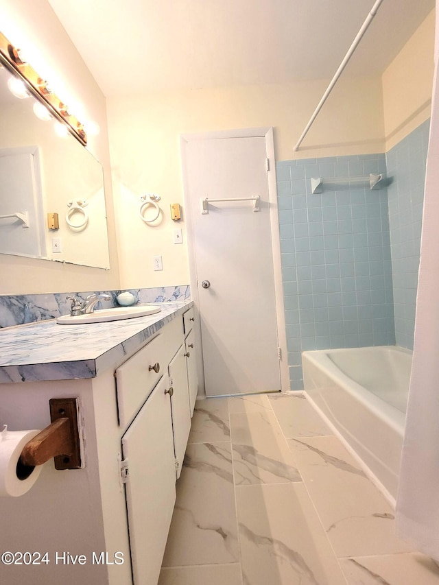 bathroom featuring vanity and tiled shower / bath combo