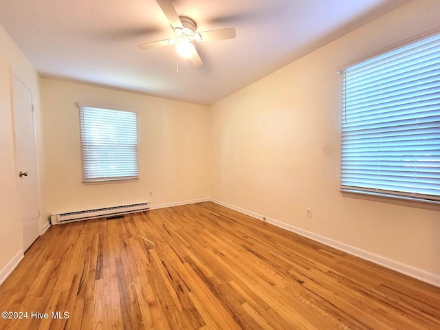 unfurnished room with ceiling fan, light wood-type flooring, and a baseboard radiator