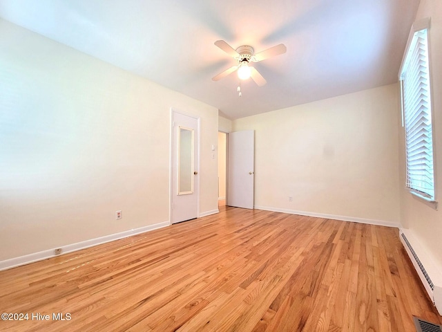 unfurnished room with ceiling fan, light hardwood / wood-style floors, and a baseboard radiator