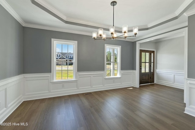 unfurnished dining area with a chandelier, a wealth of natural light, dark wood-style floors, and visible vents