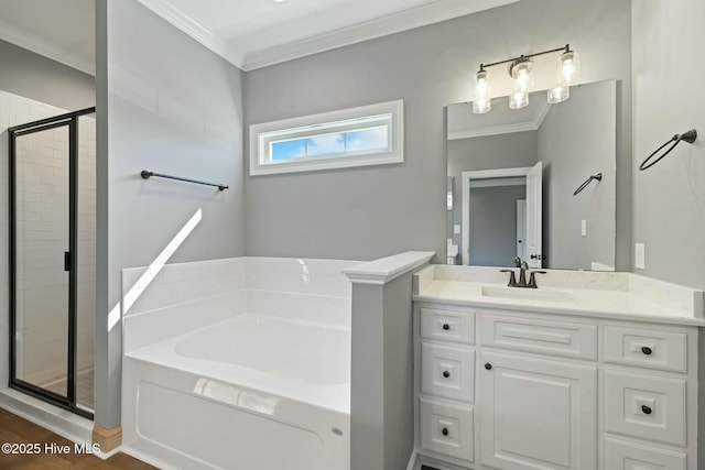 full bathroom featuring vanity, ornamental molding, a shower stall, a bath, and wood finished floors