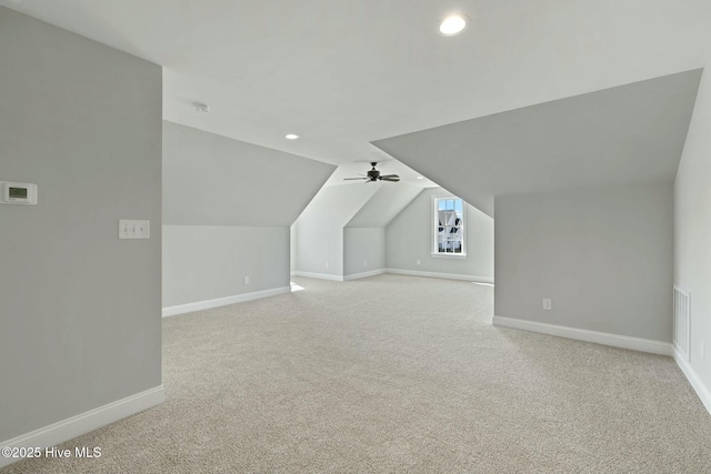 bonus room featuring light carpet, baseboards, and vaulted ceiling