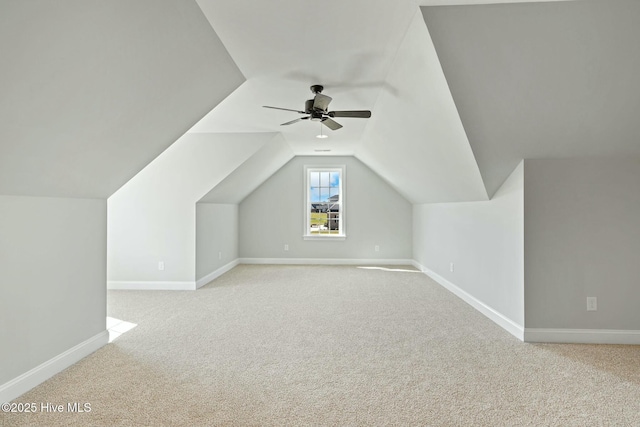 bonus room with light carpet, baseboards, a ceiling fan, and vaulted ceiling