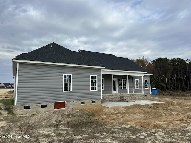 back of property with a porch