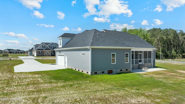rear view of house with roof with shingles, crawl space, a sunroom, and a lawn
