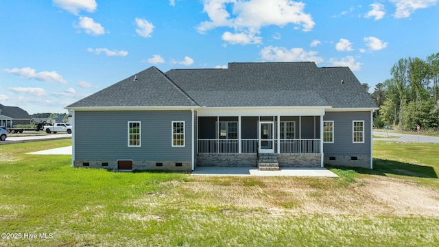 back of house with roof with shingles, crawl space, a sunroom, and a lawn