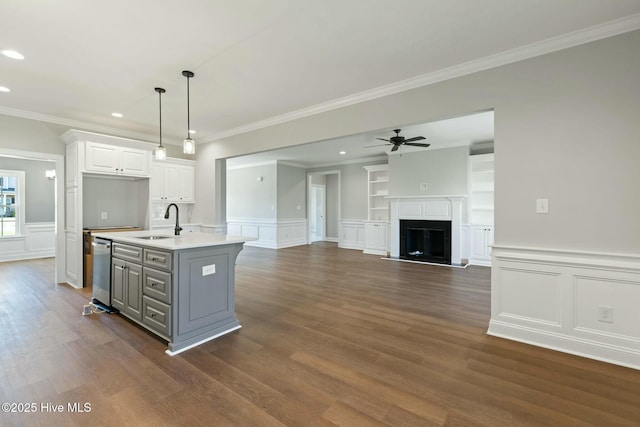 kitchen featuring a sink, light countertops, ceiling fan, gray cabinetry, and stainless steel dishwasher