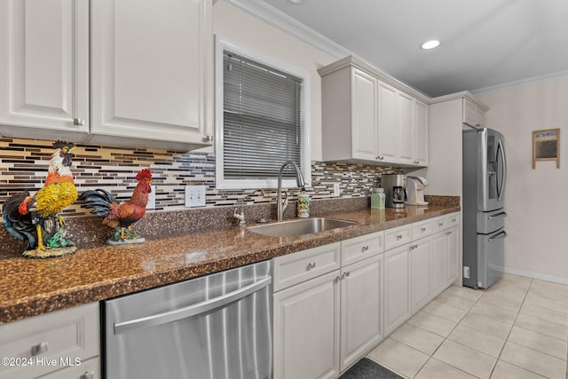 kitchen featuring white cabinets, stainless steel appliances, ornamental molding, and sink