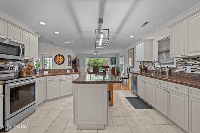 kitchen with white cabinets, stainless steel appliances, a healthy amount of sunlight, and sink