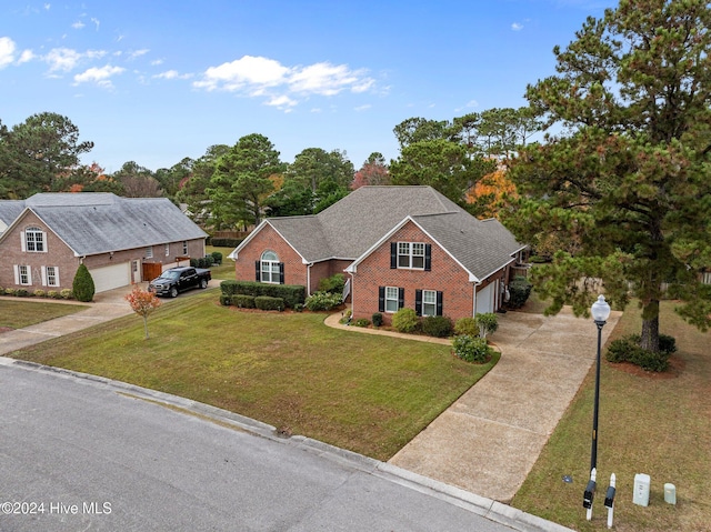 view of front of home with a garage and a front yard