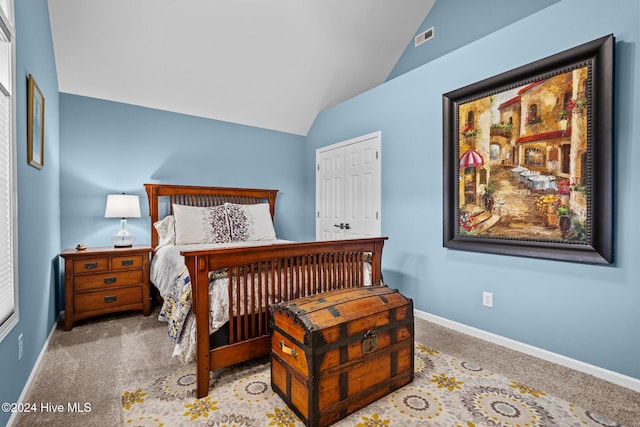 carpeted bedroom featuring vaulted ceiling and a closet