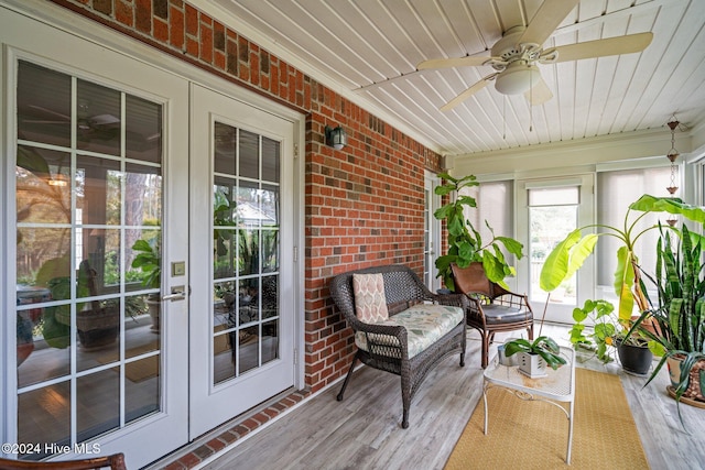 sunroom / solarium with ceiling fan and wood ceiling