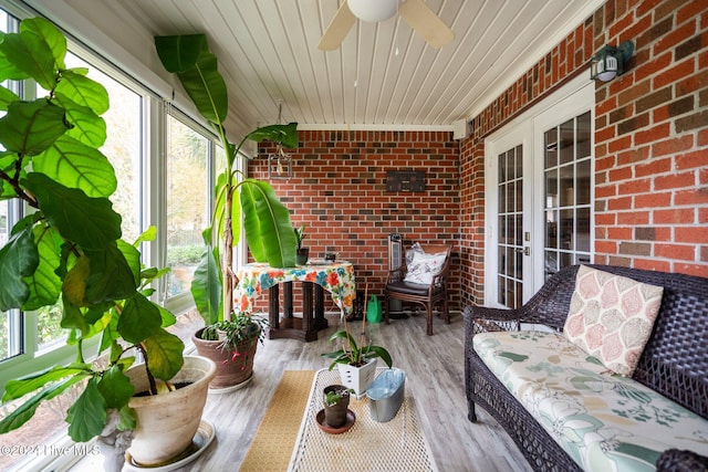 sunroom with ceiling fan and wooden ceiling