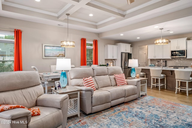 living room with beam ceiling, light hardwood / wood-style floors, ornamental molding, and coffered ceiling