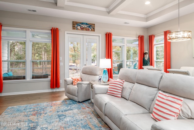 living room featuring wood-type flooring, a wealth of natural light, crown molding, and beam ceiling